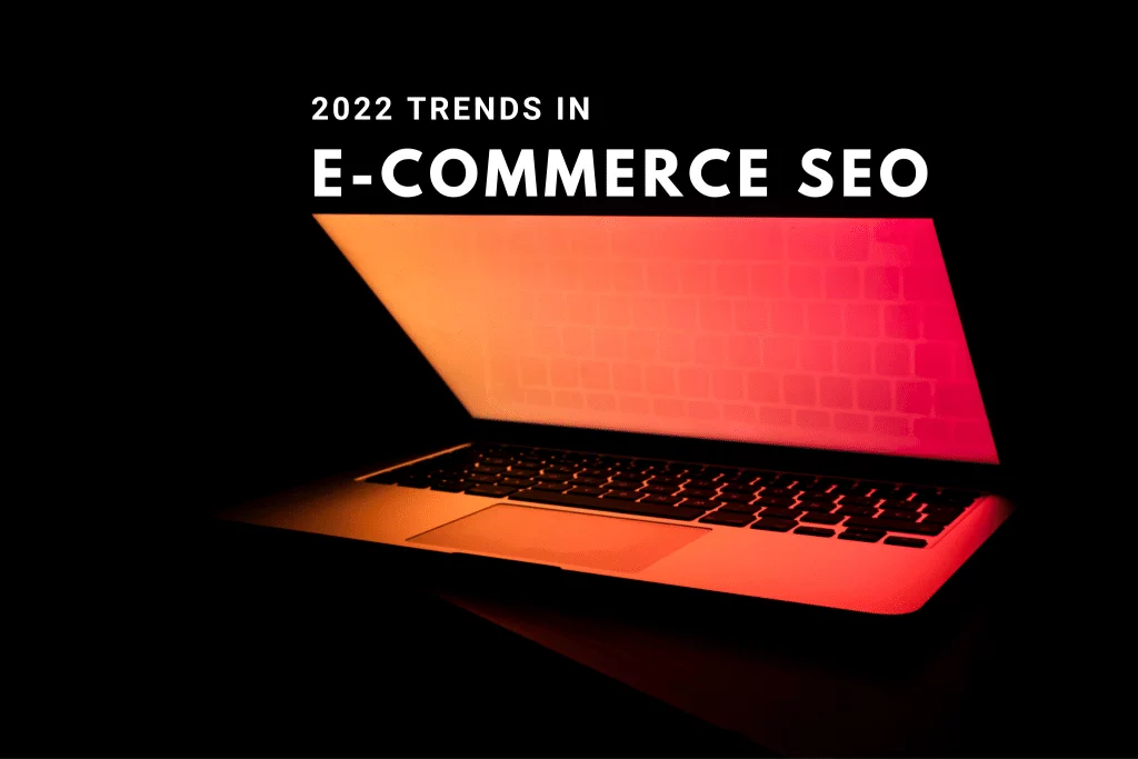 The text 2022 trends in e-commerce seo sits above a laptop half-opened with a glowing red/orange screen.
