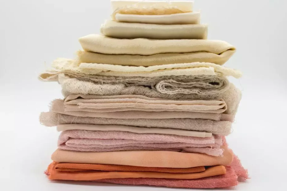 A pile of multicolored hemp fabric pieces are stacked in a neat pile.