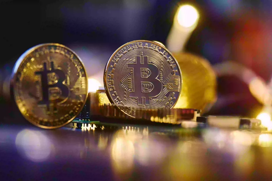 Gold bitcoins are propped up among what appears to be circuit boards