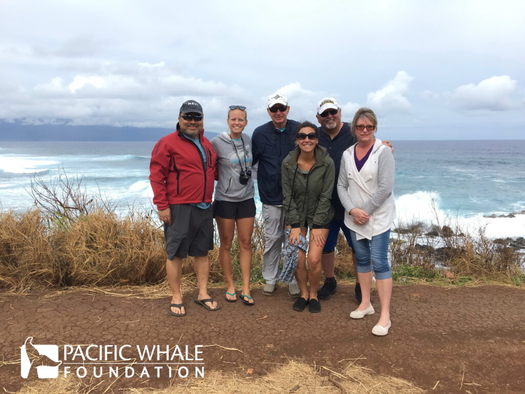 Six people including NisonCo cannabis PR Account Manager Gina Epifano stand cliffside at Ho'okipa Beach in Maui, Hawaii.